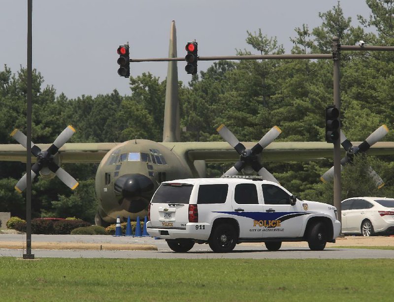 Arkansas Democrat-Gazette/STATON BREIDENTHAL --7/23/14--  A Jacksonville police vehicle drives past the main gate of the Little Rock Air Force Base Wednesday afternoon after the base was locked down about 11:45  a.m.  because of a suspicious individual. 