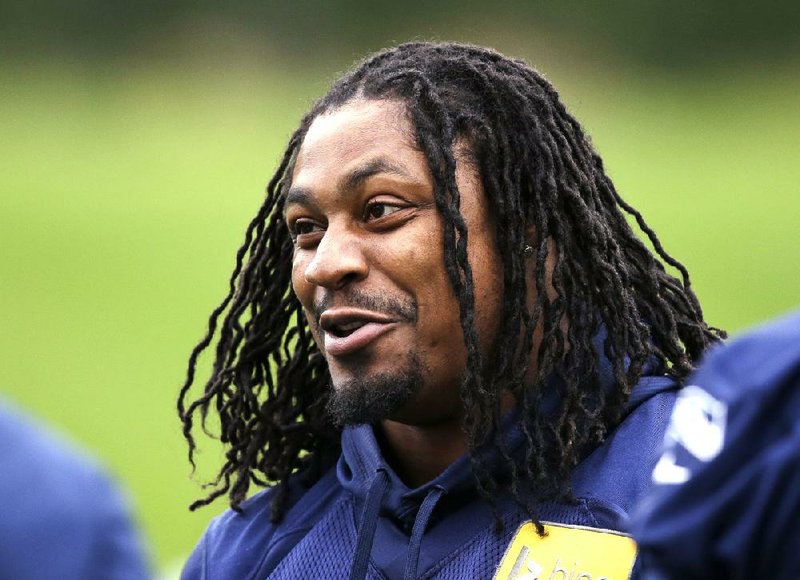 FILE - In this June 17, 2014 file photo, Seattle Seahawks' Marshawn Lynch smiles at a football minicamp practice that he watched from the sidelines in Renton, Wash. Lynch has been the workhorse Seattle has leaned on the past three seasons. He’s helped bring the team its first Super Bowl title and despite his quirks has wide-ranging respect in the locker room. (AP Photo/Elaine Thompson, File)