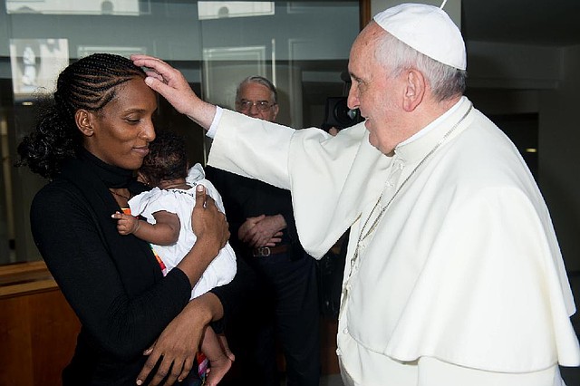 In this photo provided by the Vatican newspaper L'Osservatore Romano, Pope Francis meets Meriam Ibrahim, from Sudan, holding her daughter Maya, at the Vatican, Thursday, July 24, 2014. Pope Francis met privately Thursday with a Sudanese woman who refused to recant her Christian faith in the face of a death sentence, blessing the woman as she cradled her infant daughter born just weeks ago in prison. The Vatican characterized the visit with Meriam Ibrahim, 27, her husband and their two small children as "very affectionate." The 30-minute encounter took place just hours after the family landed at Rome's Ciampino airport, accompanied by an Italian diplomat who helped negotiate her release, and welcomed by Italy's premier, who hailed it as a "day of celebration." (AP Photo/L'Osservatore Romano, File)