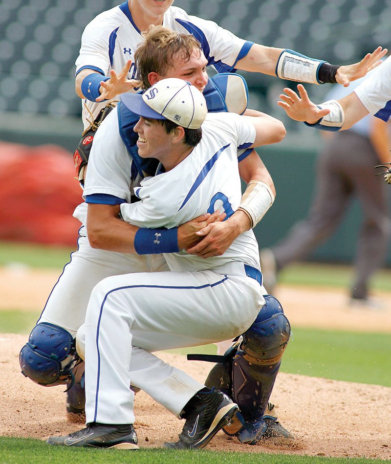 South Side Bee Branch High School catcher Josh Payne, top, tackles pitcher Brian Dumas on May 23 at Baum Stadium in Fayetteville following the team’s win over Armorel High School in the Class A state championship baseball game.