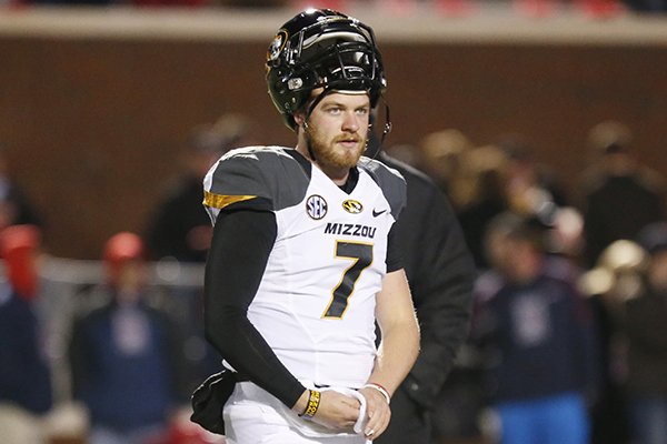 Missouri quarterback Maty Mauk (7) tries to warm up during pre-game drills prior to their NCAA college football game against Mississippi, Saturday, Nov. 23, 2013, in Oxford, Miss. No. 8 Missouri won 24-10. (AP Photo/Rogelio V. Solis)