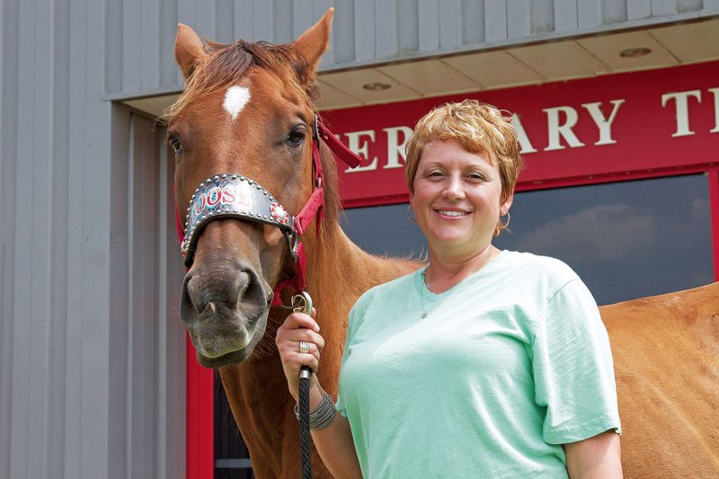 Kristie Coley, program director for the Veterinary Technology Program at Arkansas State University-Beebe, stands with Goose, one of the program’s horses.