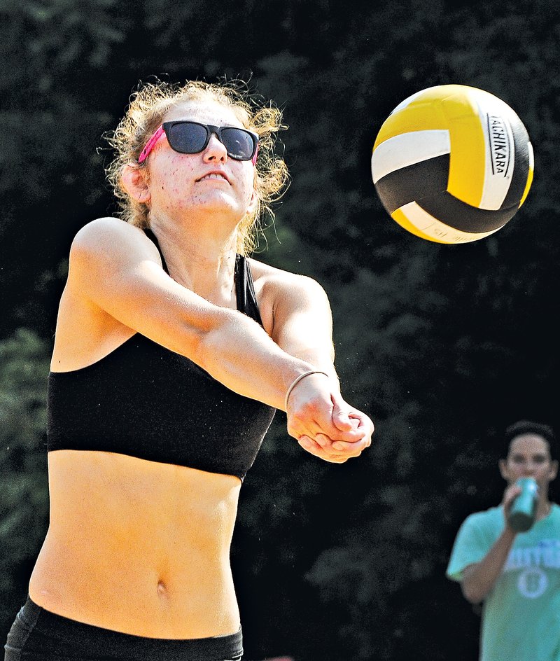  STAFF PHOTO BEN GOFF @NWABenGoff Haley Seyfarth, Bentonville senior, makes a dig during a joint practice on the sand volleyball courts at Memorial Park in Bentonville on Wednesday. The group practice included Bentonville&#8217;s varsity, junior varsity and ninth-grade squads as well as eighth-graders from Bentonville junior highs.