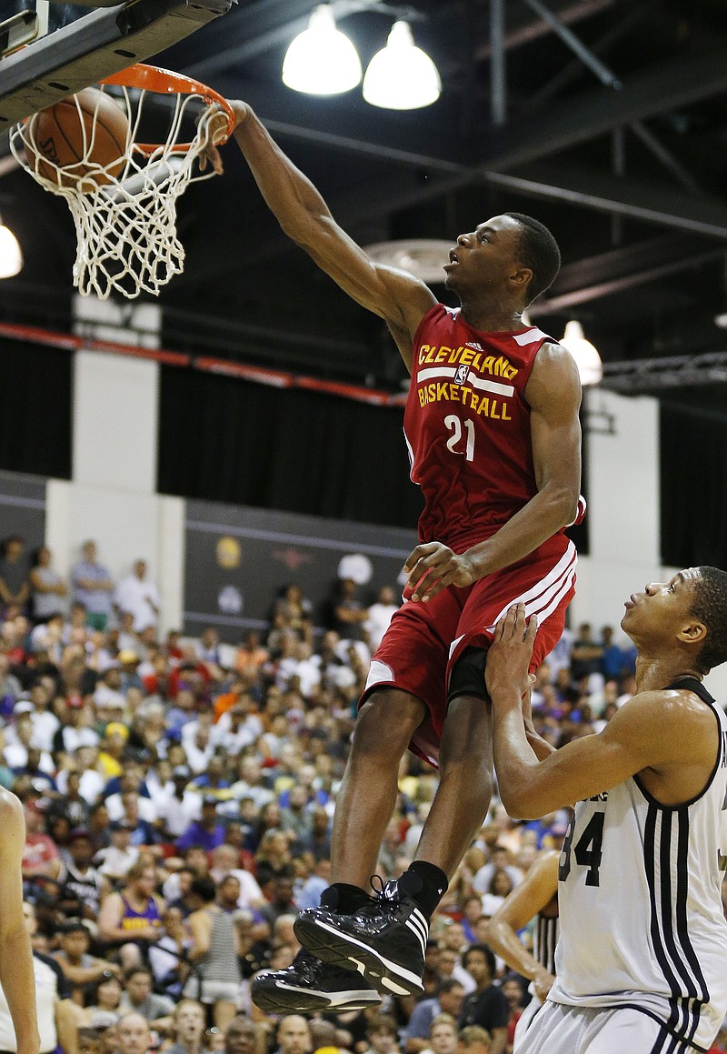 The Associated Press SIGNING DAY: Andrew Wiggins, here dunking against the Milwaukee Bucks during an NBA summer-league game July 11 in Las Vegas, signs his rookie contract with the Cleveland Cavaliers, which selected the former Kansas Star No. 1 overall in June&#8217;s NBA draft. The agreement prevents any potential trade involving the small forward from being completed for 30 days, a person familiar with the negotiations said.
