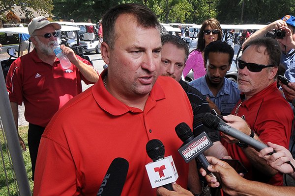 Bret Bielema, Arkansas football coach, speaks to the media prior to the George Billingsley NWA Razorback Club Celebrity Scramble golf tournament at the Kingsdale Golf Complex in Bella Vista on Friday, July 25, 2014. 