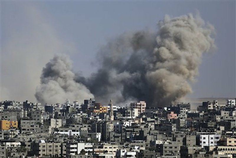Smoke from an Israeli strike rises over the Gaza Strip on Friday, July 25, 2014. Israeli warplanes struck houses throughout the Gaza Strip as international efforts continue to broker a cease fire in the 18-day-old war. 