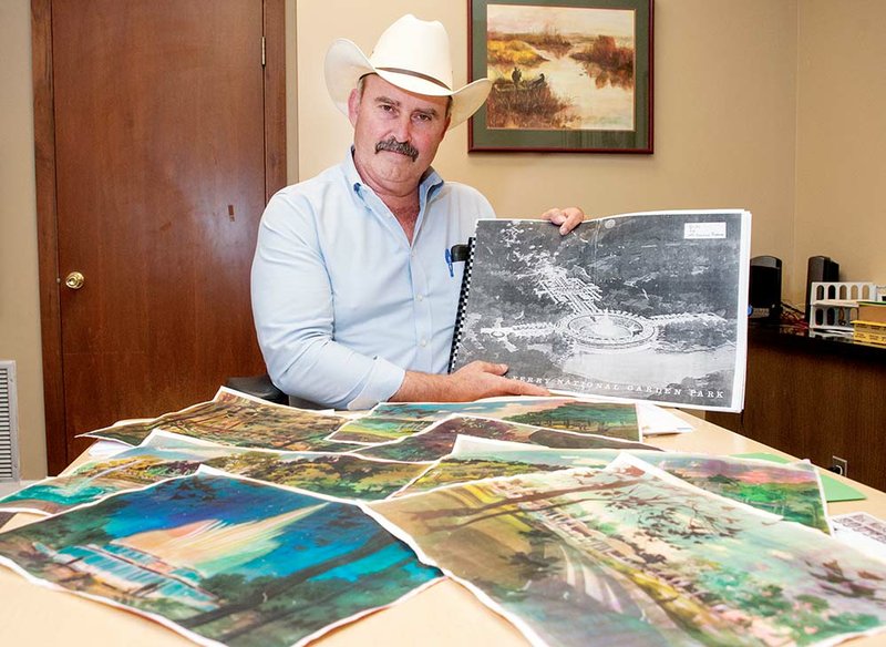 Cleburne County Judge Jerry Holmes holds one of the drawings from the 1960s for fountains and gardens near the Greers Ferry Dam in Heber Springs. The project started as the idea of a Heber Springs businessman who fell in love with gardens in Italy and proposed the idea to his friend Sen. J. William Fulbright of Arkansas. President John F. Kennedy, at the dam dedication in 1963, gave the go ahead for plans for the project to be drawn, Holmes said, but was assassinated a few weeks later. The project has been resurrected by Holmes and Billy Lindsey of Heber Springs. The men said the project has support from federal, state and local officials.