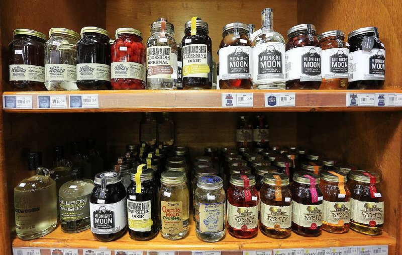 Still and all, various brands and different flavors of moonshine crowd the shelves at Colonial Wines and Spirits in Little Rock and other liquor stores.