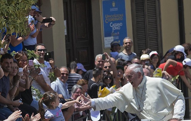 Pope Francis greets the crowd during a visit to southern Italy in June. A new survey by the Pew Research Center shows that members of various faith groups, such as Catholics, tend to have more positive feelings about people who share similar religious views.