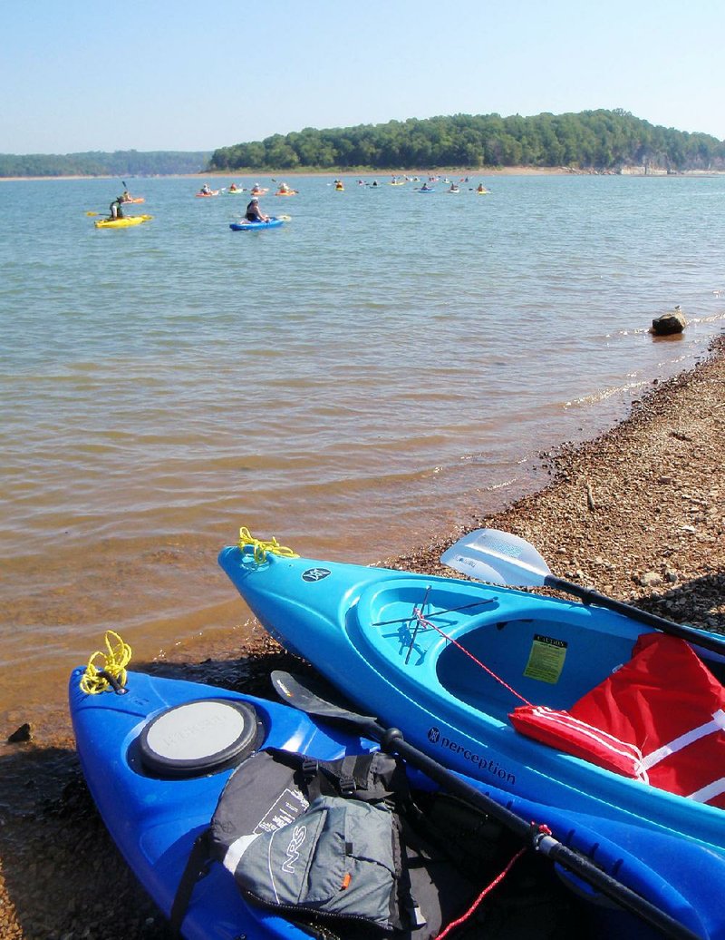 Kayakers head for Island 49 on Lake Ouachita last month. The island soon will be off-limits and the home of a $100 million prison facility known as “Arkansas Alcatraz.”