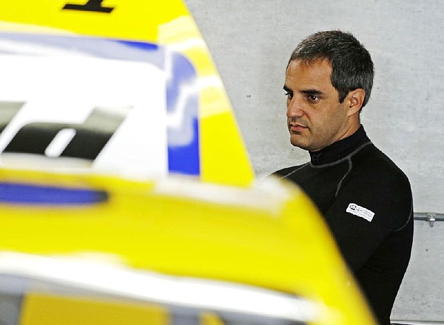 Driver Juan Pablo Montoya waits as the crew works on his car before practice for the Brickyard 400 Sprint Cup series auto race at the Indianapolis Motor Speedway in Indianapolis, Friday, July 25, 2014. (AP Photo/Darron Cummings)