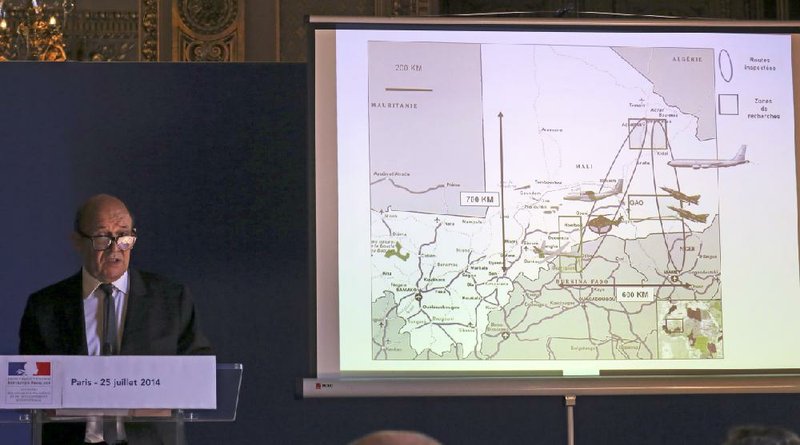 French defense minister Jean-Yves Le Drian addresses reporters during a press conference held at the foreign ministry in Paris, Friday July 25, 2014 after a plane crashed in Mali. At least 116 people were killed in Thursdays disaster, nearly half of whom were French. One of two black boxes was recovered from the wreckage in the Gossi region of Mali near the border with Burkina Faso, and was taken to the northern city of Gao, where a French contingent is based. The drawing projected at right shows the means used for the searches by French Army. (AP Photo/Remy de la Mauviniere)