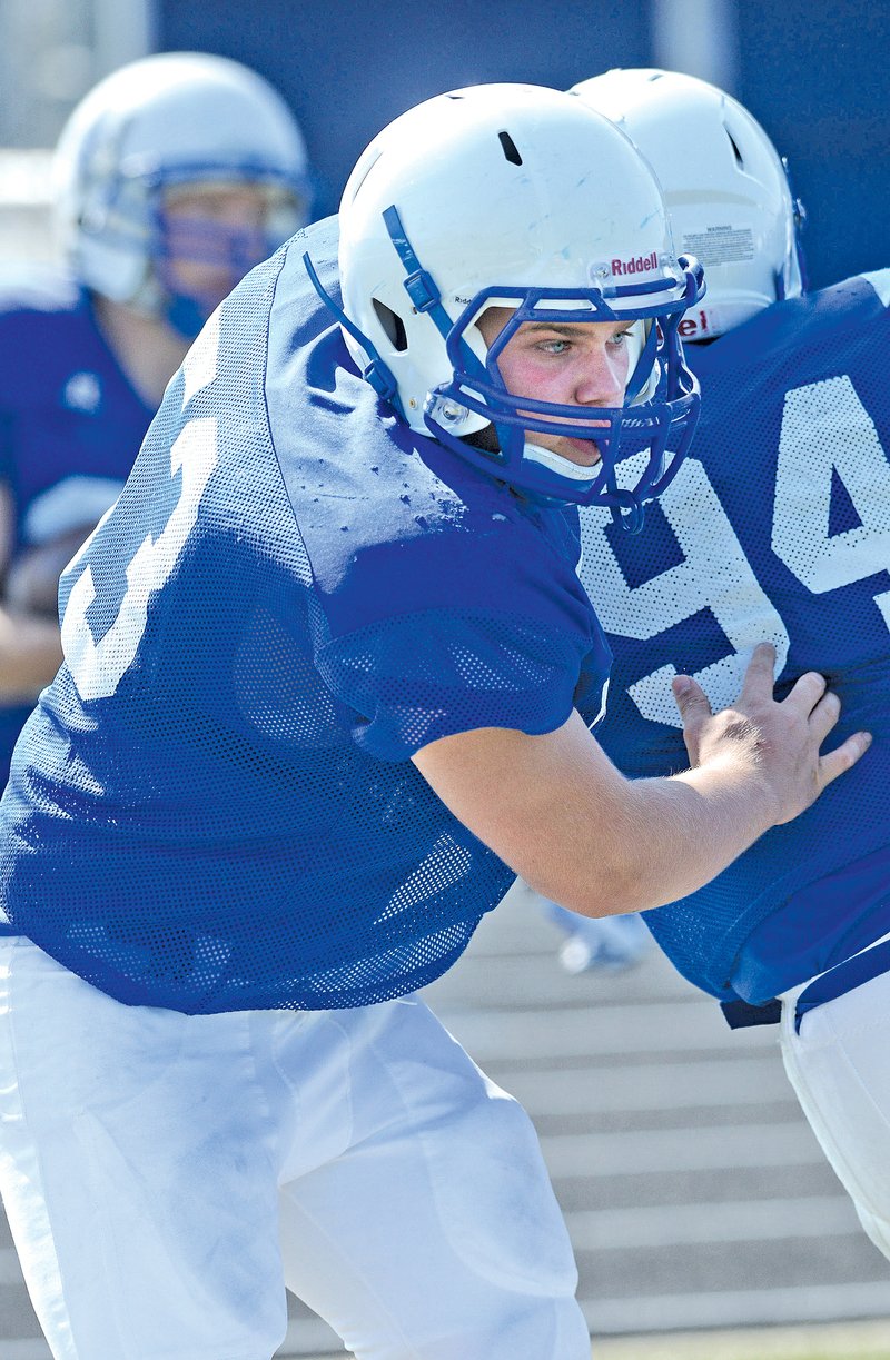  STAFF PHOTO SAMANTHA BAKER &#8226; @NWASamantha Tanner Campbell breaks through the offensive line during drills on May 21 at Whitey Smith Stadium at Rogers High.