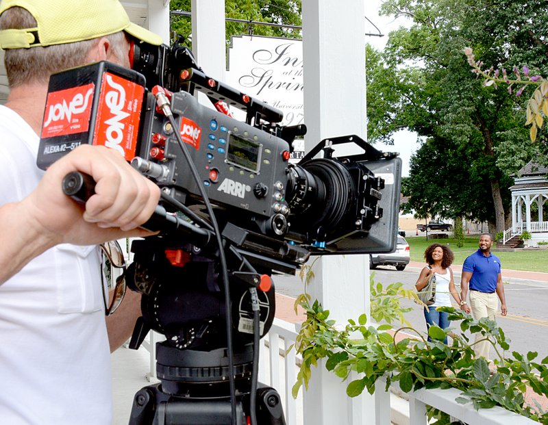 Janelle Jessen/Siloam Sunday Videographer Dan Waymack filmed two actors walking in front of Inn at the Springs on Wednesday for an Arkansas Parks and Tourism Department commercial. The film crew also took footage at Pour Jon&#8217;s Coffee and Vinyl, 28 Springs and the Siloam Springs Whitewater Recreation Park. The material will be used in the department&#8217;s 2015 advertising campaign.