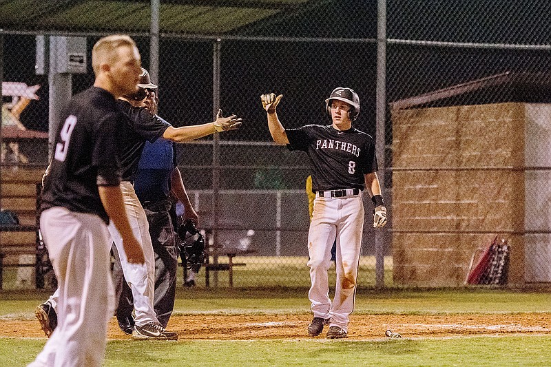 Bud Sullins/Special to Siloam Sunday Siloam Springs outfielder Cole Reed celebrates with a teammate after scoring the winning run Friday in the Panthers&#8217; 5-4 win against Long Beach, Miss., in the 15-year-old Babe Ruth Southwest Region Tournament.