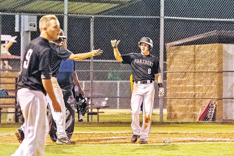 Special To NWA Media Bud Sullins Cole Reed, Siloam Springs outfielder, celebrates with a teammate after scoring the winning run Friday in the Panthers&#8217; 5-4 victory against Long Beach, Miss., in the 15-year-old Babe Ruth Southwest Region Tournament.