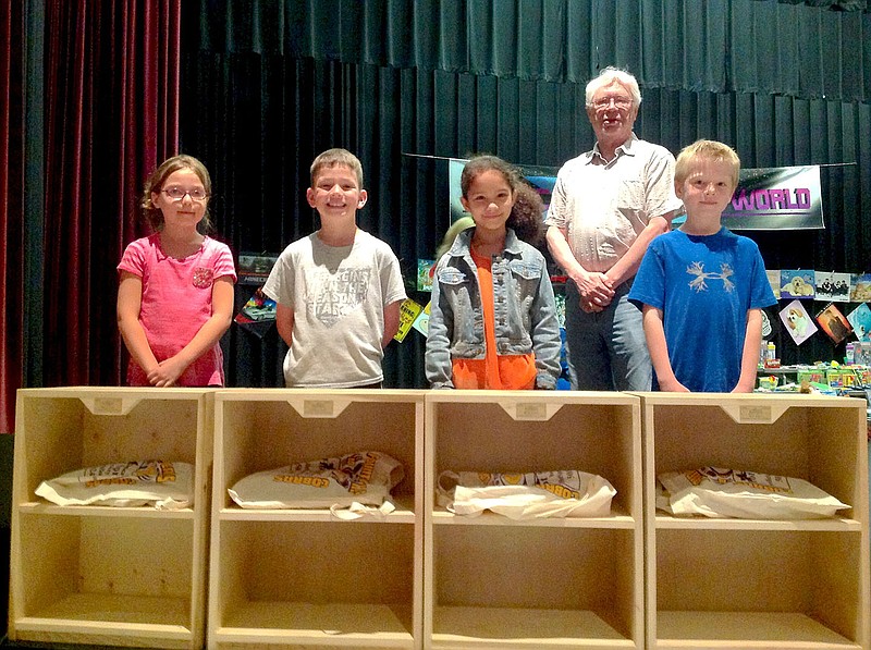 Submitted photo Fountain Lake Elementary second graders, from left, Kelsey Cook, Keith Collins, Leila Davis and Caden George present their books and bookcases from the Hot Springs Village Woodworkers of America. Lee Smith, back, presented them to the students during an assembly on May 19. Woodworkers present the rewards each year to students who have shown the most growth in reading. Kindergarten students who received rewards were: Spencer Adams, Madison Mills, Jase Vaughn, Devin Hogeland, Grady Watson and Alyssa Martinez; first grade, Jessica Parris, Abigail Hedrick, Emily Black, Lane Defoor, Caden McCormick and Linlee Hardin; third grade, Katelynn Foshee, Nathaniel Price, Garrett White, Kaylie Safley, Logan Terry and Rebecca Martinez; fourth grade, Starla Hensley, Zach Helfrich, Brayden White, Christina Larsen, Kaylee Sheffield and Isaac Perez. Second grader Wyatt Clem also received books and a bookcase.