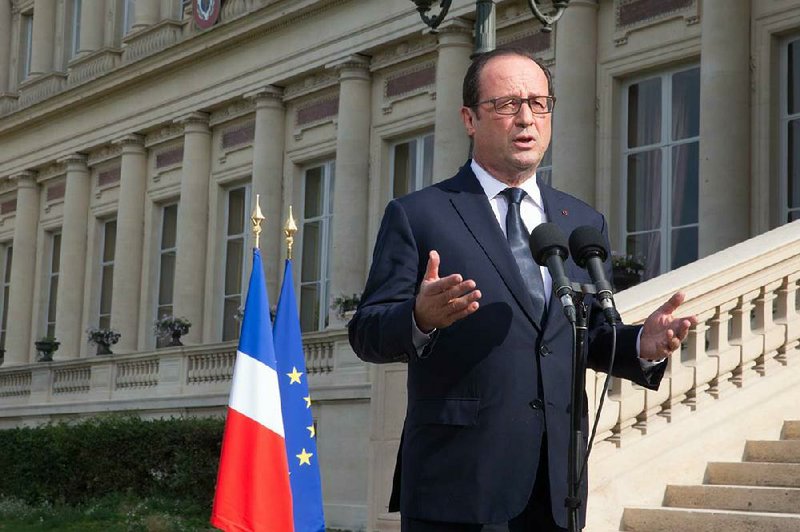 French President Francois Hollande speaks Saturday outside the Foreign Affairs Ministry in Paris after meeting with the families of Air Algerie plane crash victims.