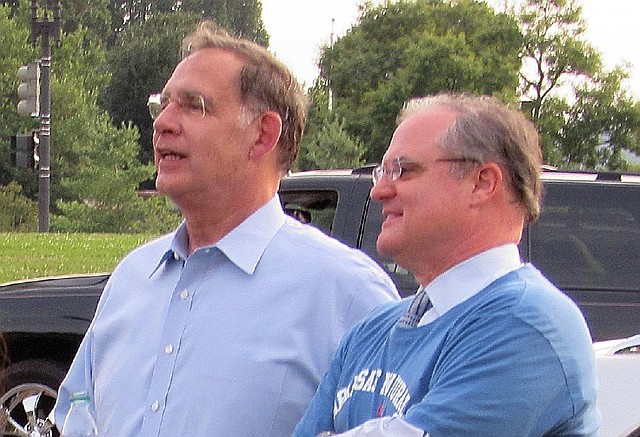 U.S. Sens. John Boozman (left) and Mark Pryor watch the annual softball game Monday that their staffs play on the National Mall in Washington. Boozman’s team won for the fourth year in a row.