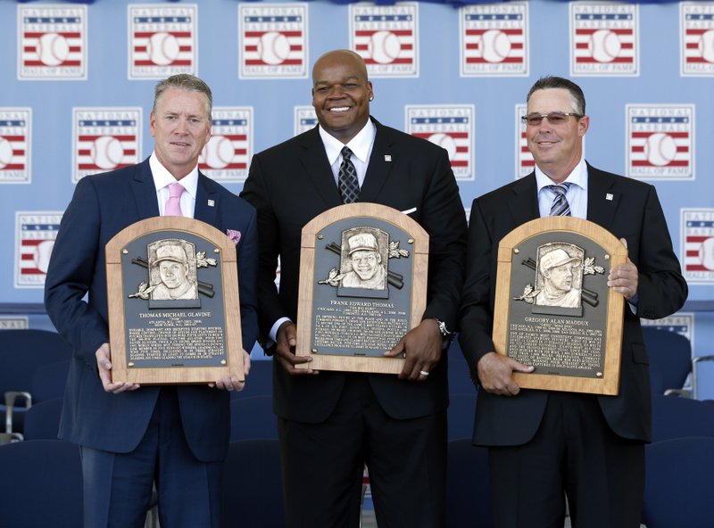 National Baseball Hall of Fame inductees Tom Glavine, Frank Thomas and Greg Maddux hold their plaques after an induction ceremony at the Clark Sports Center on Sunday, July 27, 2014, in Cooperstown, N.Y.