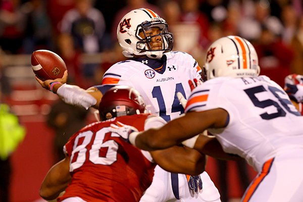 Auburn quarterback Nick Marshall is pressured by Arkansas defensive end Trey Flowers during the third quarter of their game Saturday, Nov. 2, 2013 at Razorback Stadium in Fayetteville. 
