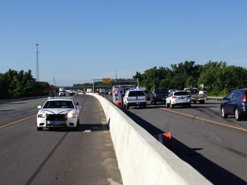 Interstate 40 East traffic slows Monday morning, July 28, 2014, after a wreck requires a medical helicopter to land on the highway.