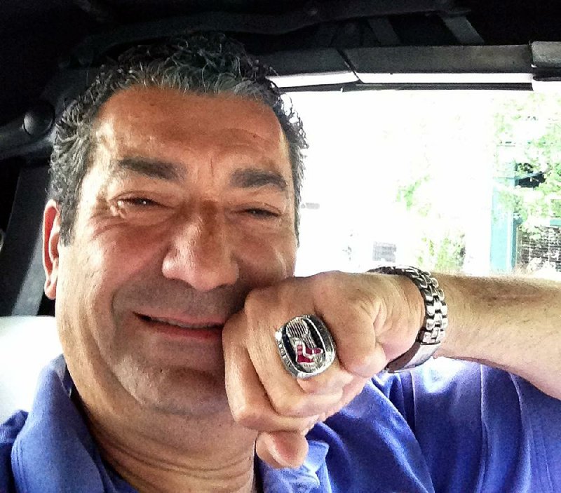 In this Friday, July 25, 2014, photo provided by Luigi Militello, New York Yankees fan Militello displays the 2013 Red Sox World Series ring he found at his New York restaurant on Thursday night. Militello returned the ring on Friday to Drew Weber, who owns one of Boston's minor league teams. (AP Photo/Luigi Militello)