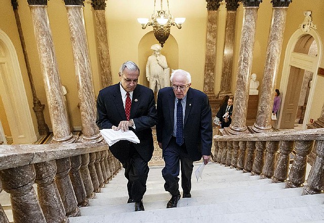 Senate Veterans’ Affairs Committee Chairman Sen. Bernie Sanders, I-Vt., right and House Veterans’ Affairs Committee Chairman Rep. Jeff Miller, R-Fla., take the stairs to a news conference on Capitol Hill, in Washington, Monday, July 28, 2014, about a bipartisan deal to improve veterans' health care that would authorize at least $17 billion to fix the health program scandalized by long patient wait times and falsified records covering up delays. (AP Photo/J. Scott Applewhite)