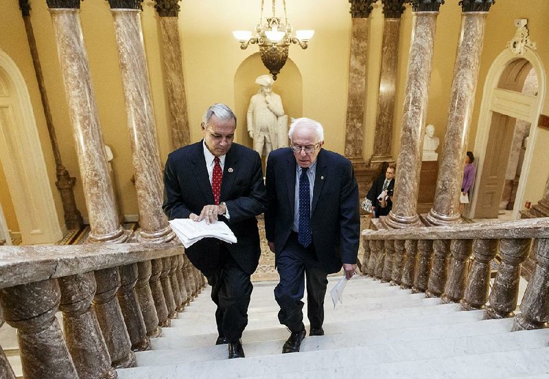Senate Veterans’ Affairs Committee Chairman Sen. Bernie Sanders, I-Vt., right and House Veterans’ Affairs Committee Chairman Rep. Jeff Miller, R-Fla., take the stairs to a news conference on Capitol Hill, in Washington, Monday, July 28, 2014, about a bipartisan deal to improve veterans' health care that would authorize at least $17 billion to fix the health program scandalized by long patient wait times and falsified records covering up delays. (AP Photo/J. Scott Applewhite)