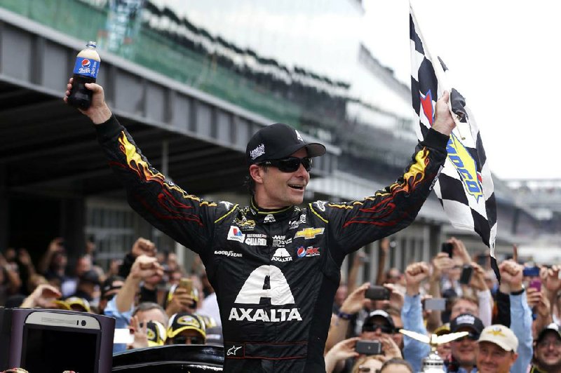 Jeff Gordon celebrates after holding off a late charge from Kyle Busch to win the Brickyard 400 for the fifth time Sunday at the Indianapolis Motor Speedway. The victory came on the 20th anniversary of Gordon’s triumph in the inaugural race in 1994 and served as the 90th of his career.