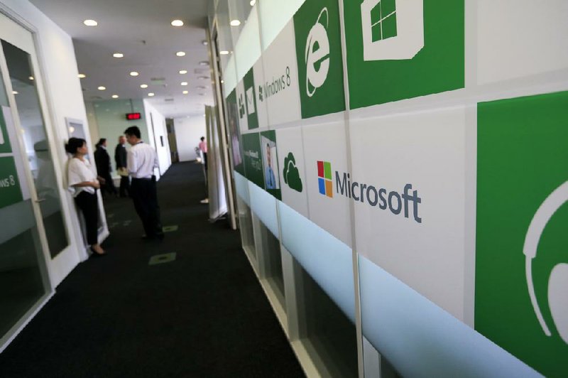 Employees work inside Microsoft Corp.’s China headquarters in Beijing in this file photo. China’s antimonopoly agency began investigating Microsoft in June after complaints Microsoft failed to publish all documentation for its Windows operating system and Office software.