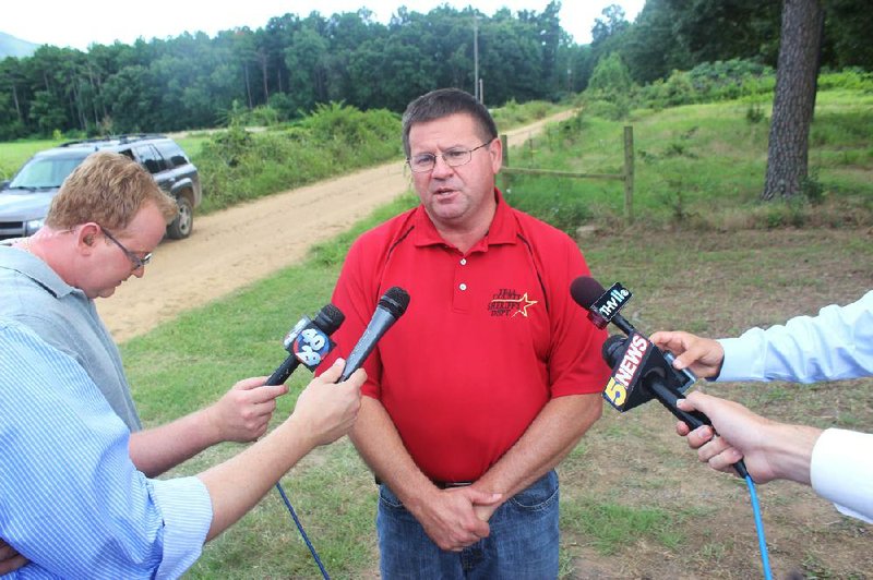 Yell County Sheriff Bill Gilkey speaks to reporters Tuesday after authorities found the bodies of Brian Floyd, 33, and his 10-month-old son, Harper, near Blue Mountain Lake.