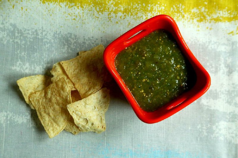 Cheater Salsa Verde is made by dressing up jarred salsa with fresh onion, cilantro, jalapeno and lime juice.