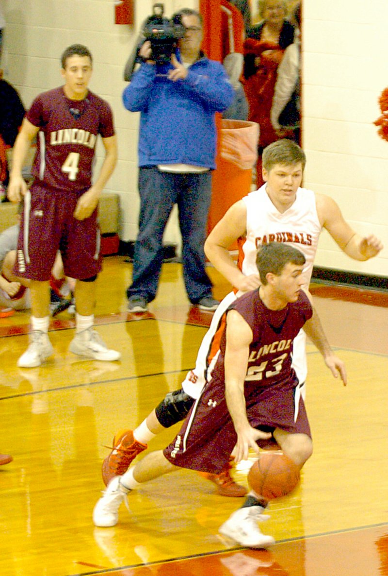 MARK HUMPHREY ENTERPRISE-LEADER Lincoln&#8217;s Justin Brewer drives into the paint against Farmington&#8217;s Mac Spears.