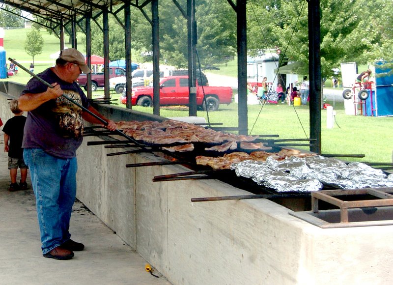 Photo by Mike Eckels The grill master stands watch over chicken halves Aug. 3, 2013, during the 60th Annual Decatur Barbecue at Veterans Park in Decatur.