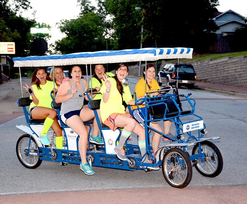 Janelle Jessen/Herald-Leader A group of six people rode on a surrey bicycle from Dogwood Junction as they turned down Broadway Street with the other cyclists.