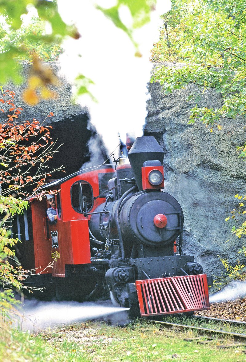 COURTESY PHOTO The locomotive pulling the Silver Dollar Line blows steam as it exits the tunnel at Silver Dollar City. The park boasts three historic steam engines to carry guests back to the Ozarks in the 1880s.