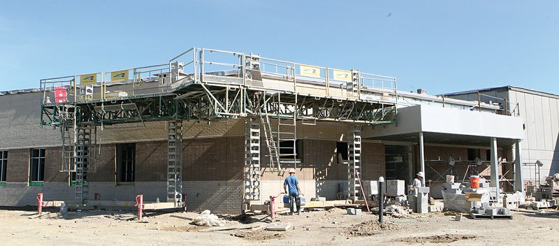 The Sentinel-Record/Richard Rasmussen BRICK BY BRICK: Construction crews lay bricks Tuesday at the new Garland County Detention Center. The Garland County Quorum Court approved job reclassifications earlier this week for administrative personnel at the jail.