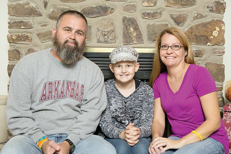 Maddie Windle is shown with her parents, Brad and Gina Windle, in October 2013.