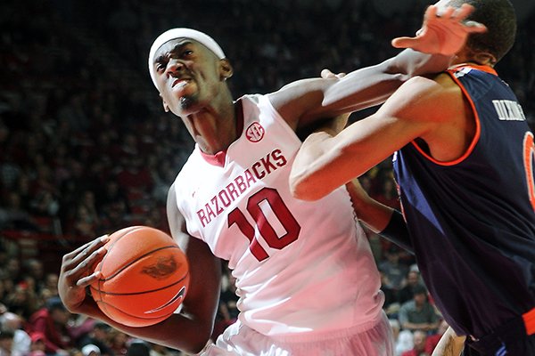 Arkansas' Bobby Portis, left, elbows out Auburn's Asauhn Dixon-Tatum Saturday, Jan. 25, 2014, during the second half of the game against Auburn at Bud Walton Arena in Fayetteville.