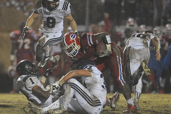 Evangel's Santos Ramirez is tackled during a game against St. Thomas More in Shreveport. 