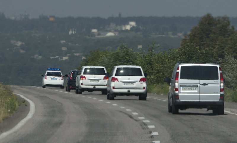 Convoy of the OSCE mission in Ukraine travel outside the city of Donetsk, eastern Ukraine, on Wednesday, July 30, 2014, as they try to estimate security conditions. 