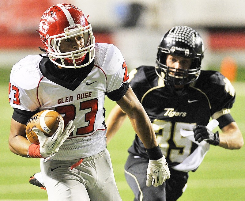 Glen Rose running back Carlos Burton (No. 23) runs away from Charleston defender Taylor King (No. 35) during the 2013 Class 3A state final in December at War Memorial Stadium in Little Rock.