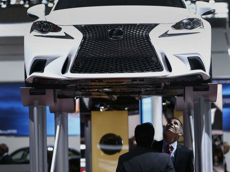 Attendees at the New York International Auto Show look at the undercarriage of a Toyota Motor Corp. Lexus IS 350 F sport vehicle in this April file photo.
