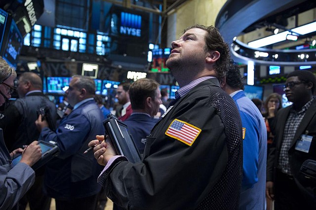Traders work Wednesday on the floor of the New York Stock Exchange.