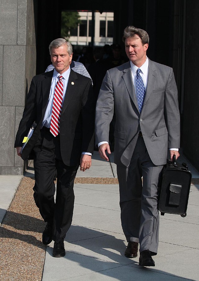 Former Virginia Gov. Bob McDonnell ( shown left) and his wife, Maureen McDonnell leave court Wednesday in Richmond after the day’s proceedings.