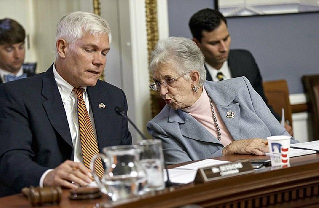 House Rules Committee Chairman Pete Sessions, R-Texas, confers with Rep. Virginia Foxx, R-N.C., as the panel meets Wednesday to take the procedural steps to authorize the House to seek a lawsuit against President Barack Obama.