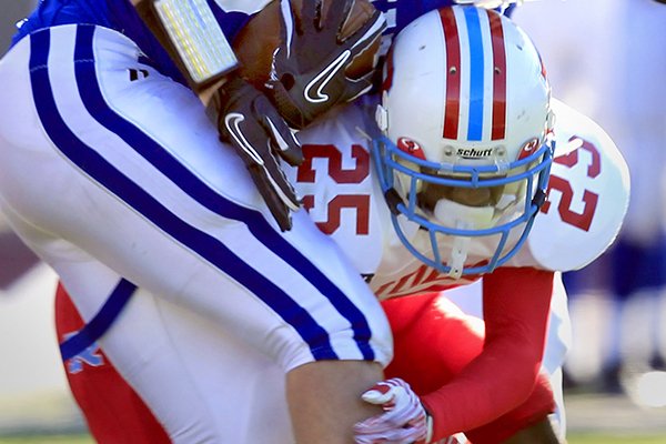 Archbishop Rummel High School's Henre' Toliver tackles Jesuit High School's Matt Baldwin at Joe Yenni Stadium in Metairie on Saturday, October 29, 2011.