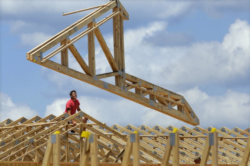 In this July 17, 2014 photo, construction workers build a commercial complex in Springfield, Ill. The government issues its first of three estimates of how fast the U.S. economy grew in the April-June quarter on Wednesday, July 30, 2014. 