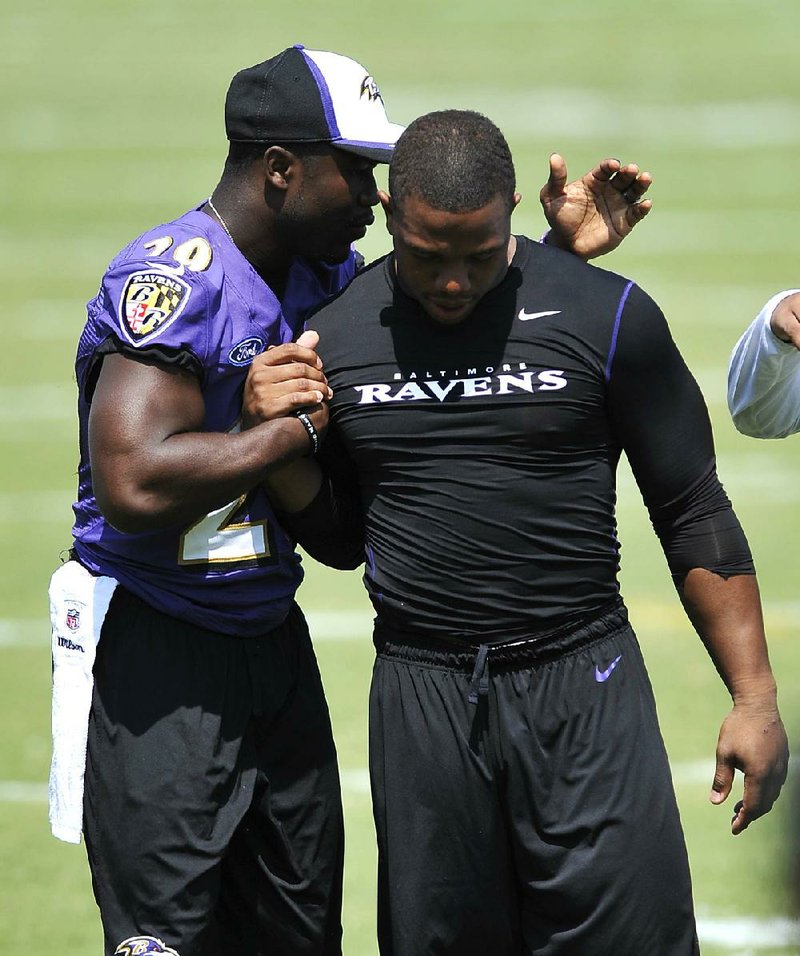 Baltimore Ravens running back Ray Rice (right) walks off the practice field with teammate Justin Forsett before addressing the media at a news conference Thursday in Owings Mills, Md. Rice was suspended two games and fined three paychecks totaling more than $500,000 after he was arrested on domestic violence charges in February.